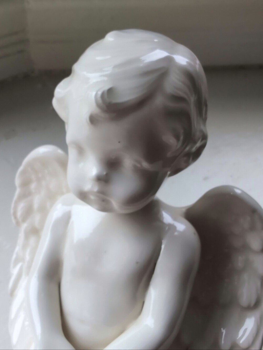 White porcelain cherub figurine